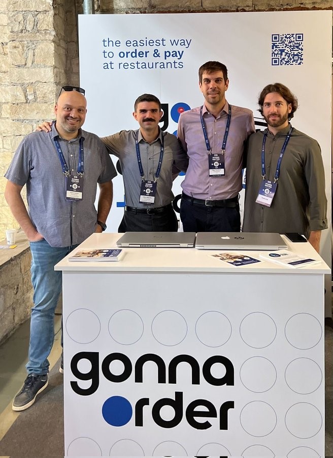 Four members of the GonnaOrder team that attended the Reflect Festival 2022 pose for a group photo.